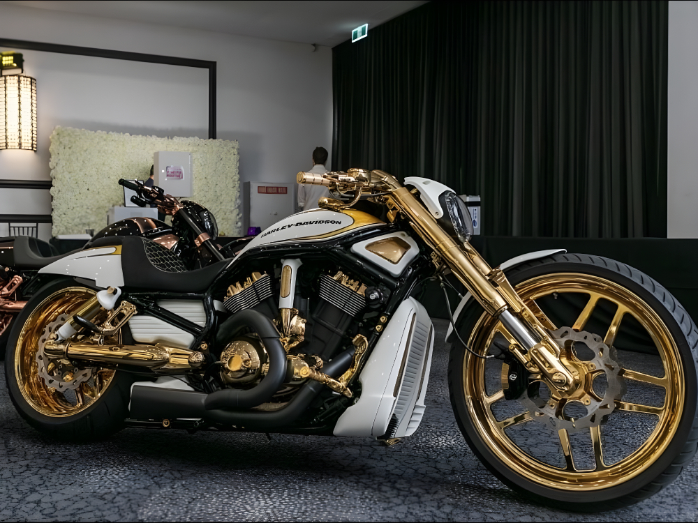Black, white and gold Harley with gold wheels on display inside an event venue