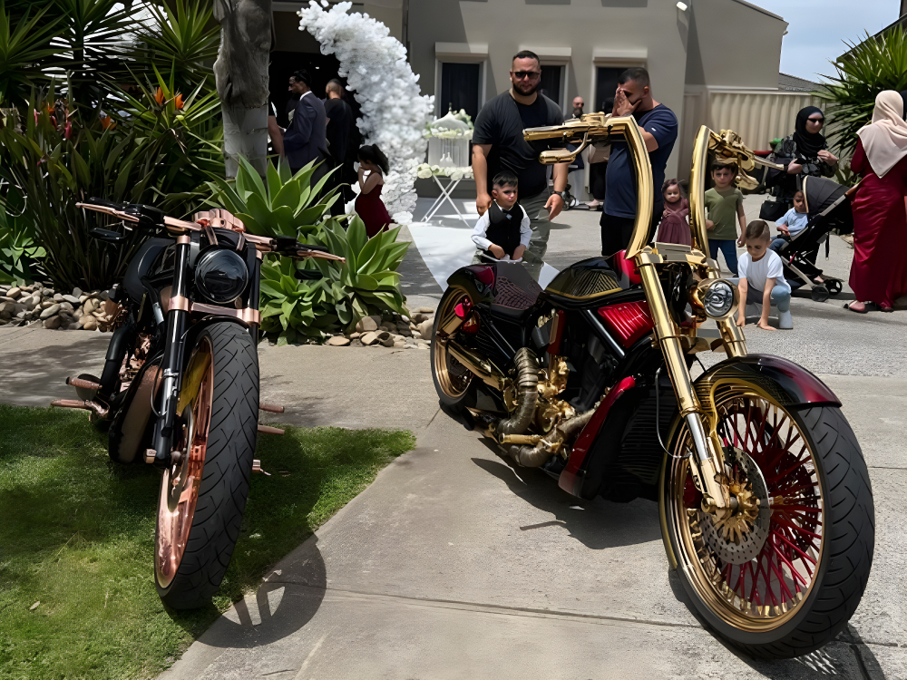 Gold and copper Harleys parked on a garden path at a family celebration